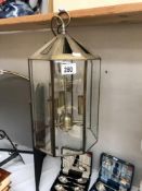 An antiqued brass finished hall lantern with 8 bevelled glass panels