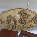 A large oval relief plaque featuring Chinese landscape and characters.