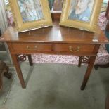 An oak side table with drawer.