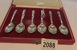A cased set of hall marked silver teaspoons with crown finials. Approximately 85 grams.