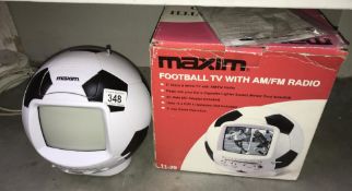 A boxed Maxim football TV with AM/FM radio