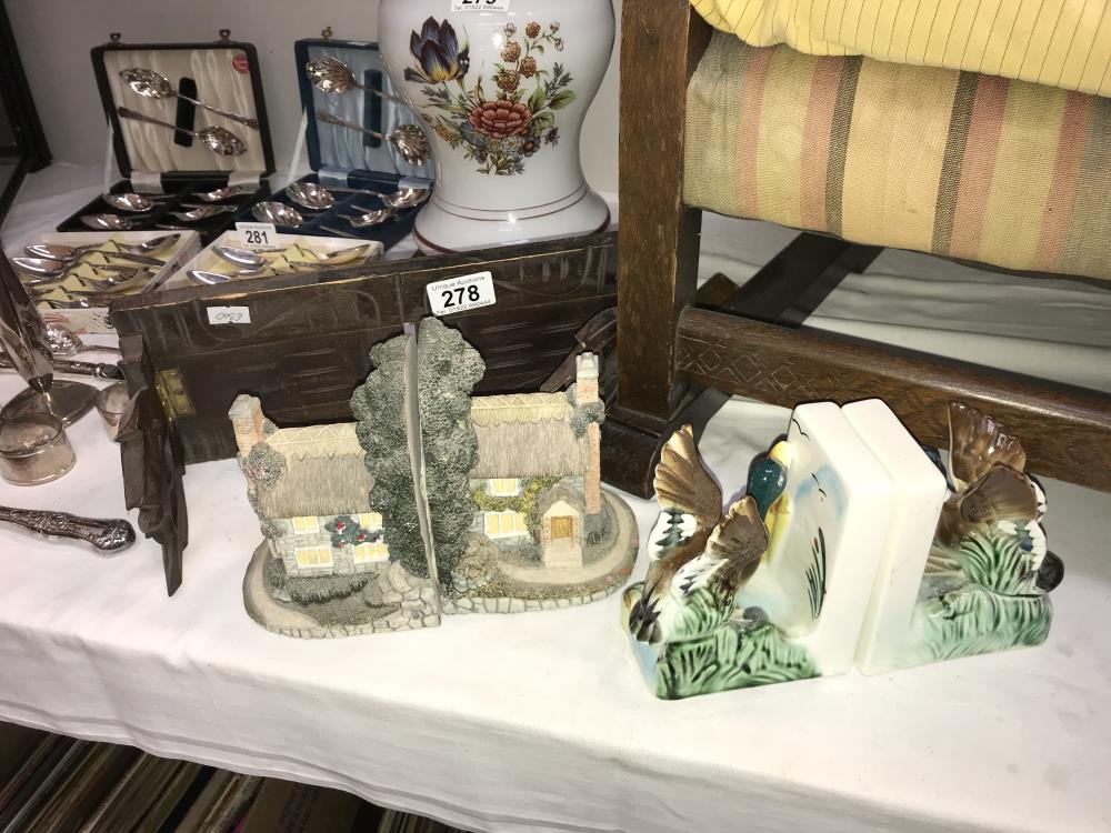A pair of cottage bookends and 2 other sets