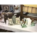 A pair of cottage bookends and 2 other sets