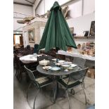 A metal patio table and 4 chairs and parasol