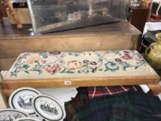 A long oak footstool with tapestry top