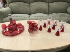 A ruby lacquered glass drinks set including decanter and tray