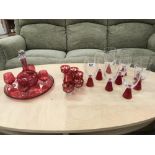 A ruby lacquered glass drinks set including decanter and tray