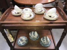 A gilt decorated cries of London sweet oranges trios and blue and white cups and saucers