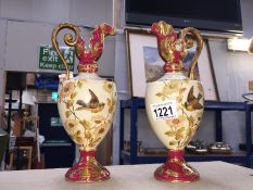 A pair of 19th Century Ewer vases with painted birds and flowers