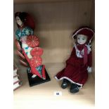 A vintage oriental doll and 1 other