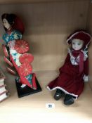 A vintage oriental doll and 1 other