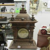 A large wood cased mantel clock.
