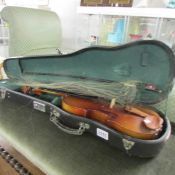 A cased violin with a/f bow.