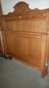 A Edwardian light oak bedstead.