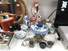 A collection of Chinese items including figures, spoons, sensors,