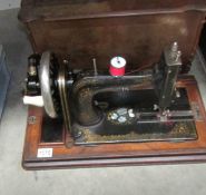 A cased hand operated sewing machine.