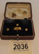 5 gold collar studs (approximately 3 grams) and 2 others.