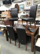 A modern mahogany dining table and 4 leather chairs