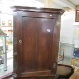 An oak corner cupboard.