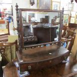 A Georgian dressing mirror in mahogany with three drawers.