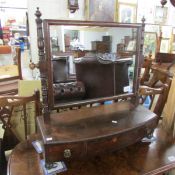A Georgian dressing mirror in mahogany with three drawers.