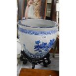 A large blue and white planter on stand (chip to rim),