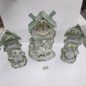 A 3 piece continental porcelain clock garniture.