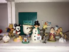 A collection of Disney figurines including WDCC, Mickey Mouse, Tigger, Jim Shore, Royal Doulton etc.