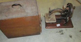A Wilcox & Gibbs sewing machine with case.