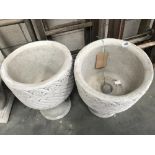 A pair of conrete planters