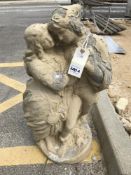 A painted concrete statue of a romantic couple