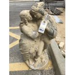 A painted concrete statue of a romantic couple