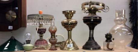 A quantity of oil lamps and shades