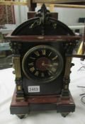 A black slate and marble mantel clock.