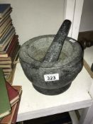 A heavy pestle and mortar