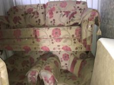 A floral patterned upholstered 3 piece suite