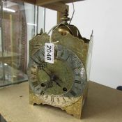 A brass lantern clock.
