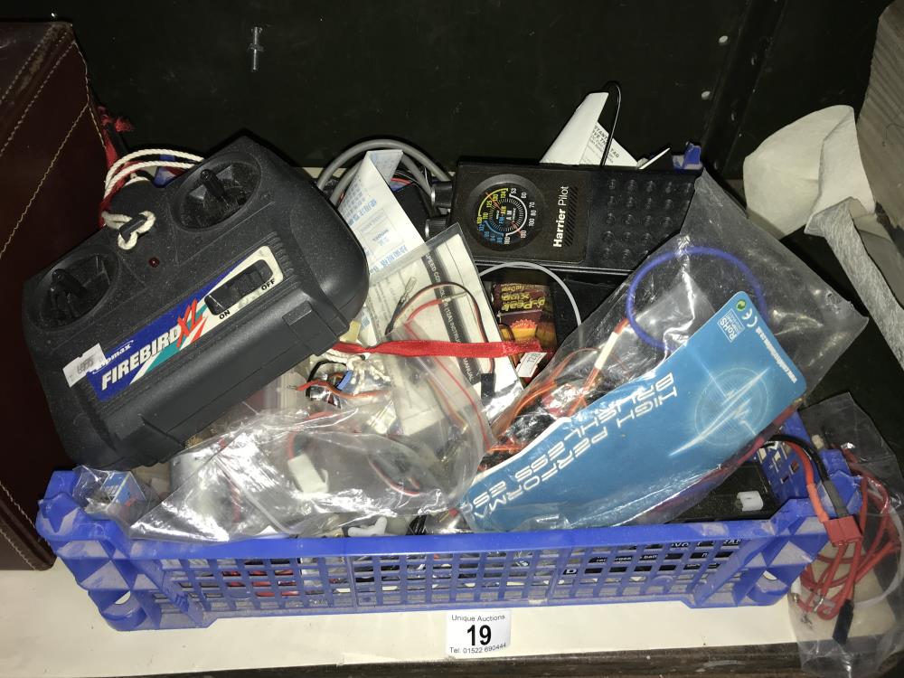 A box of model radio control equipment including batteries, motors etc.