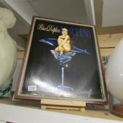 A framed Blue Dolphin Martini advertisement.