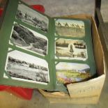 An album of approximately 156 postcards and a quantity of modern postcards.