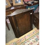 A mahogany corner cupboard.