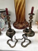 A pair of Georgian copper candlesticks and a pair of Indian brass cobra candlesticks