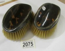 A pair of silver and tortoise shell hair brushes, hall marked E. S. Barnsley & Co., Birmingham.