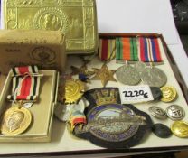 A collection of WW1 and WW2 medals together with other memorabilia.