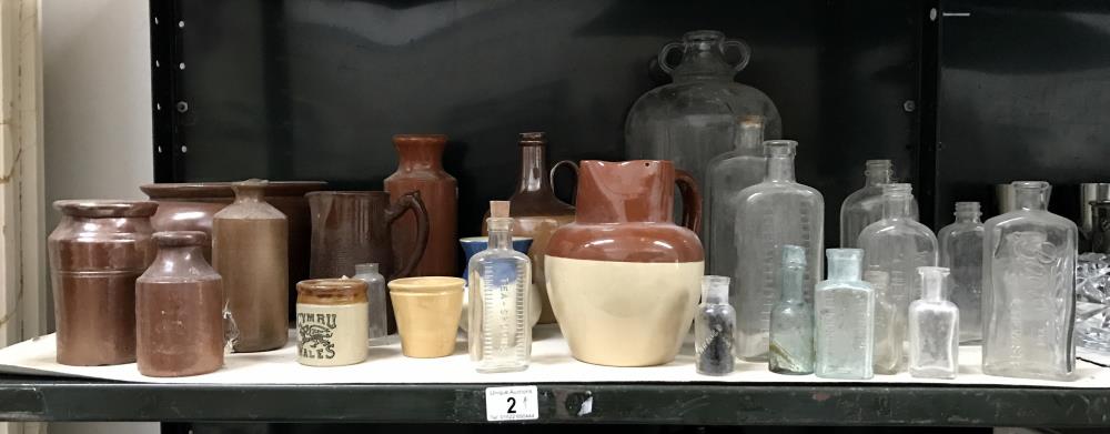 A shelf of stoneware jugs,