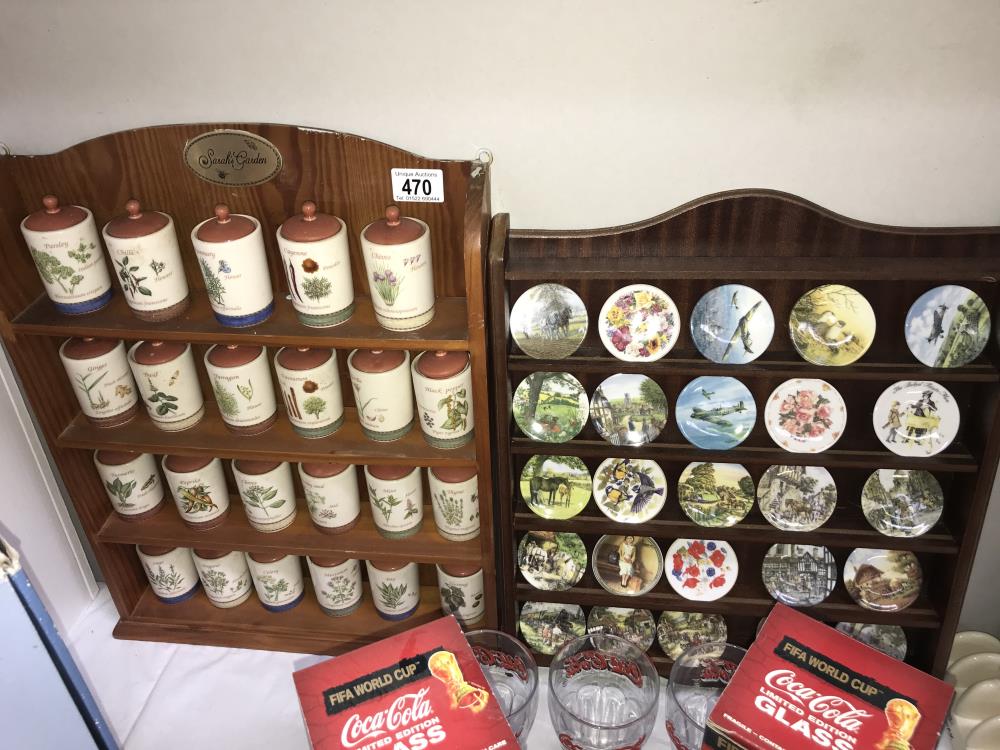 A Centenary collection of small plates on a rack and Sarahs Garden spice jars on rack