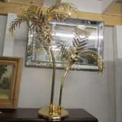 A gilded table lamp in the form of palm trees.