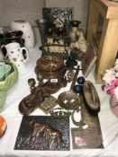 A box of metalware including cast iron door stops, brass vases etc.