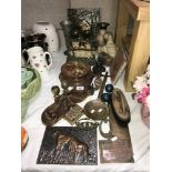 A box of metalware including cast iron door stops, brass vases etc.