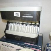 A boxed coin sorter.